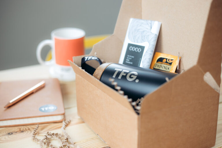 6 reasons why we love branded merch; a client gift box with a branded flask