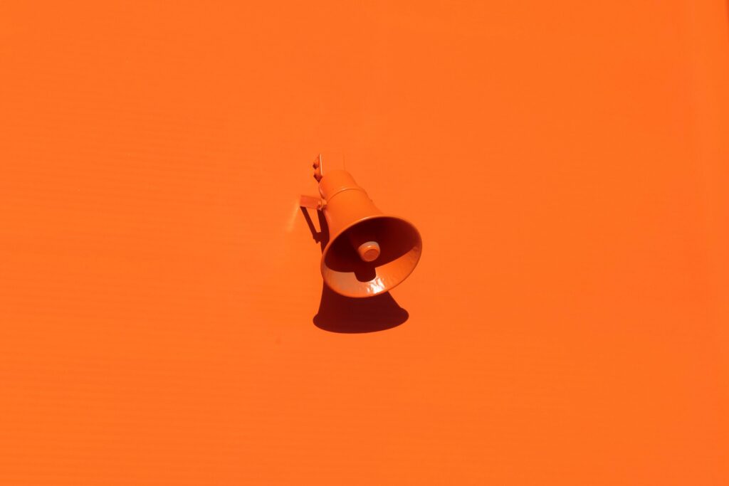 Orange megaphone on an orange backdrop