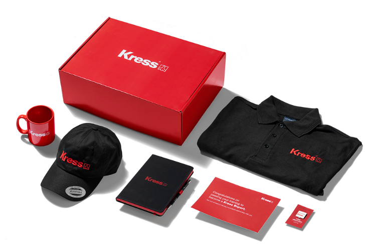 Image: Kress custom portal swag options for their customers, showing a tshirt, cap, mug, flask and a box on a white background