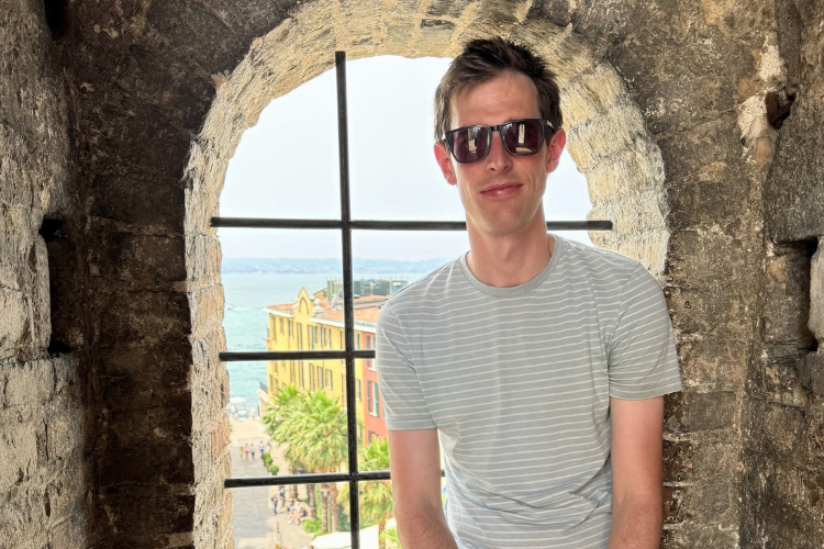 Image: Luke Symes of Clone Media sat in a window of a brick building