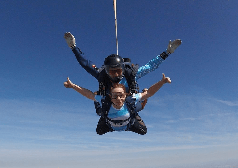 Image: Becky Swain, Accounts Assistant from Clone jumping out of a plane doing a skydive