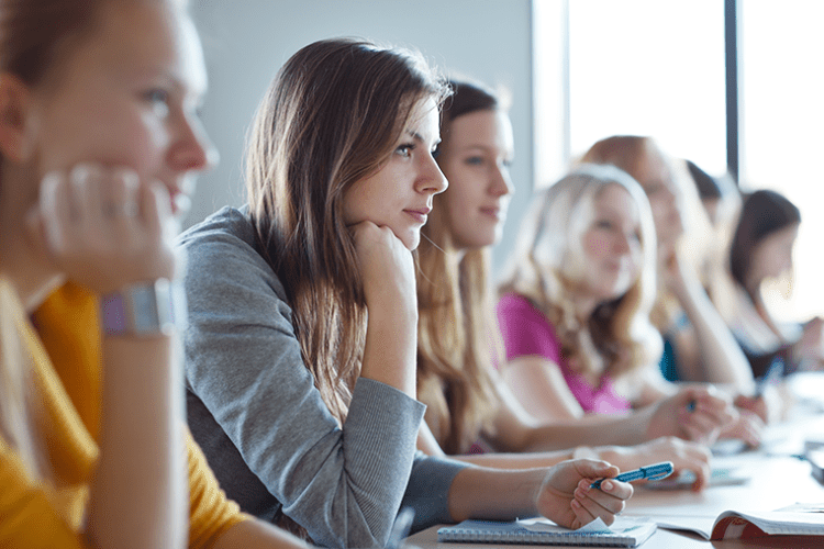 Image: Students leaning forward listening in a classroom